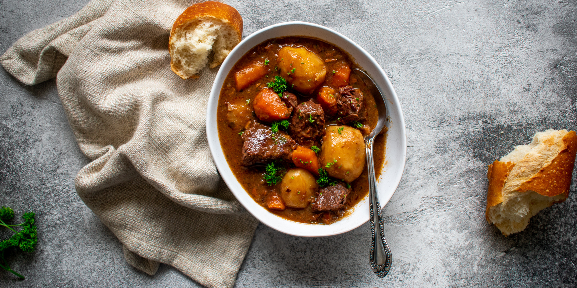 Image of Beef & Guinness Stew on table with bread