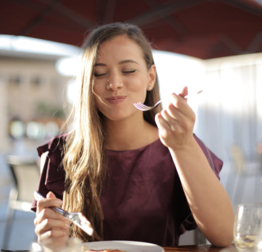 Young woman with ADHD eating food happily 