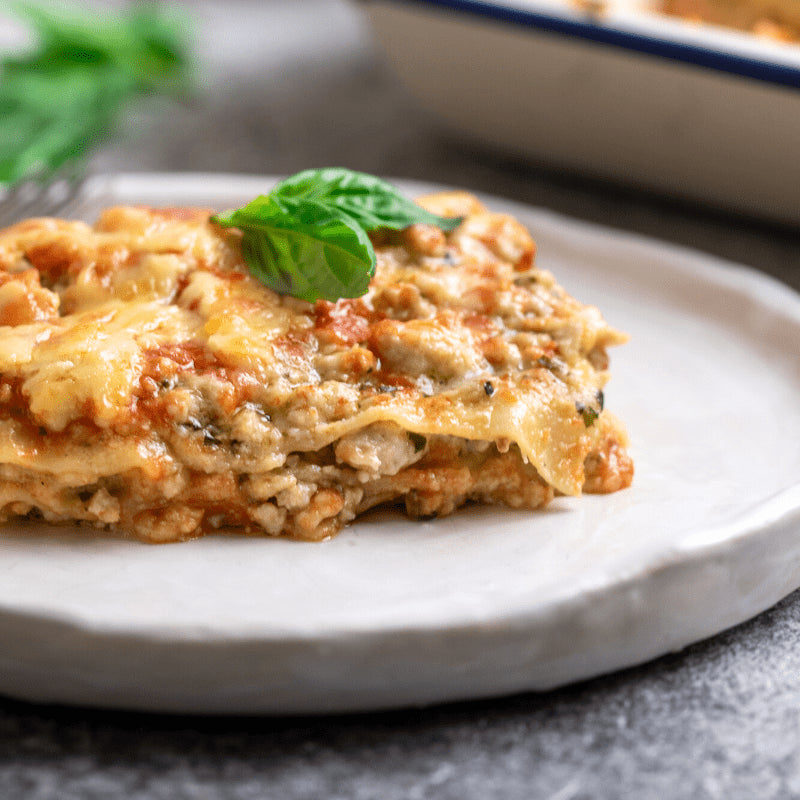 Image of a piece of Chicken Pesto Lasagne on a white plate