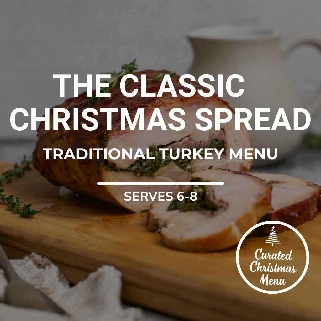 Sliced turkey on a wooden board with text about a traditional Christmas menu.