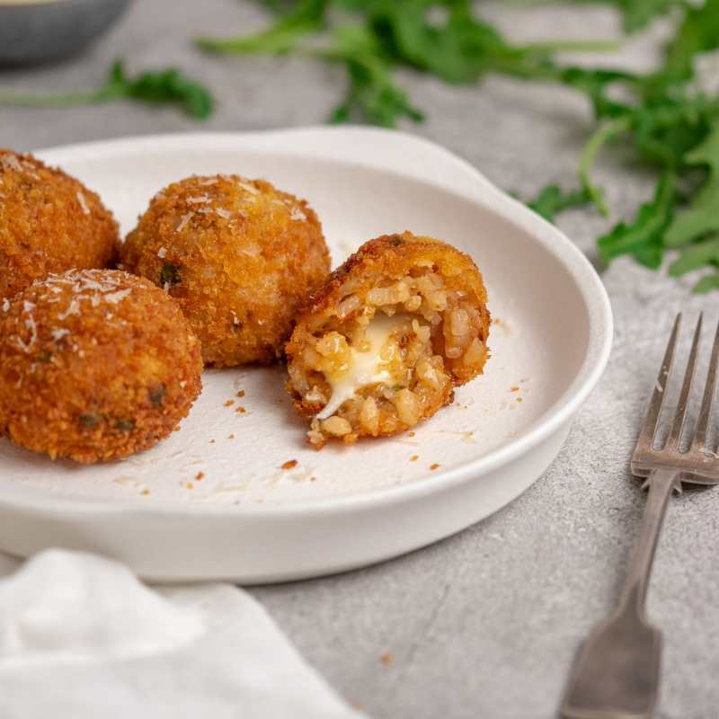 Davide's Sicilian Arancini piled up on a plate