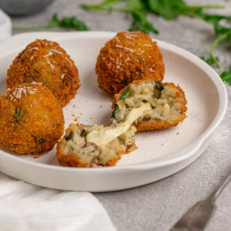 Image of Davide&#39;s Spinach &amp; Mushroom Arancini on a plate with cheesy centre