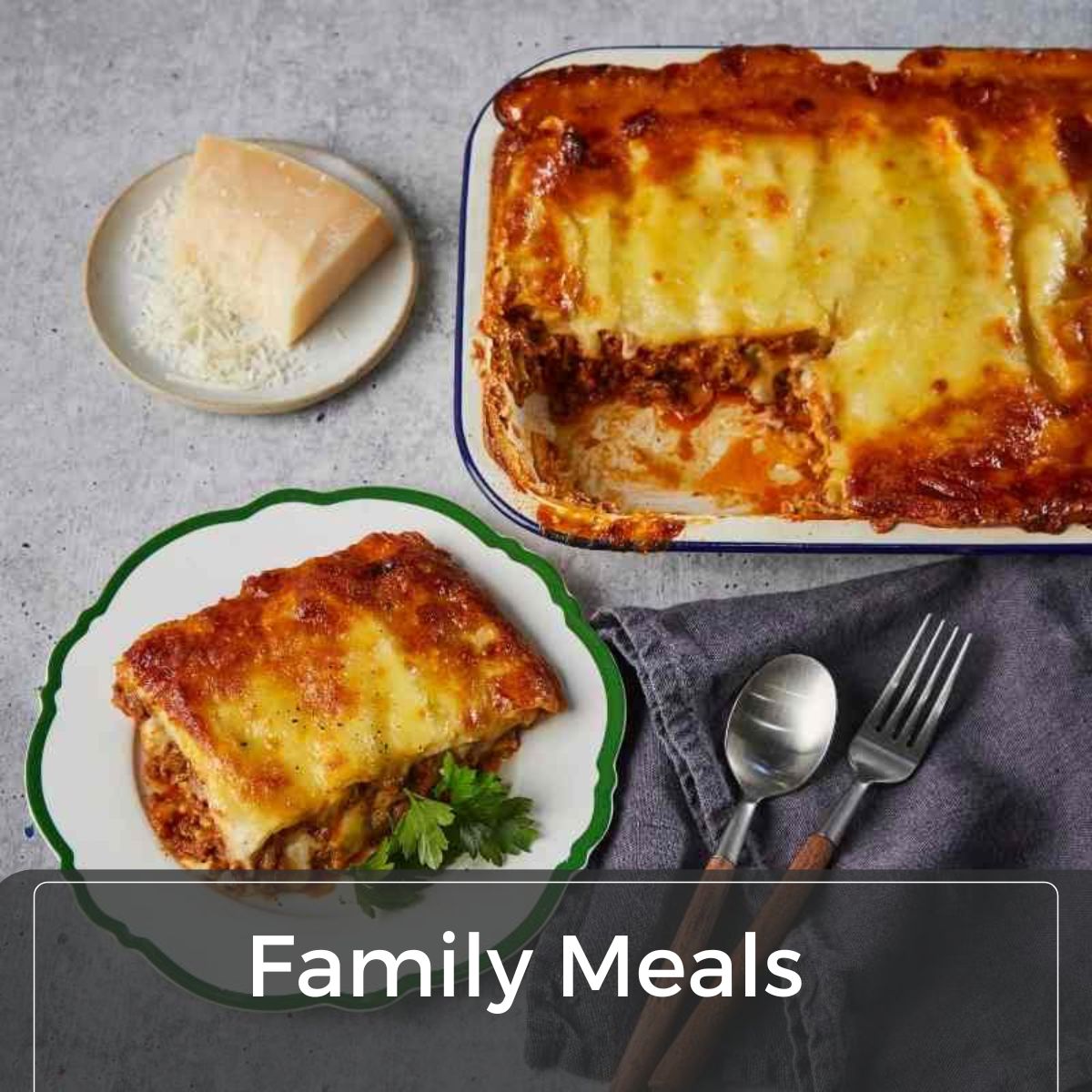 Image of Lasagne in a tray with a piece cut out and placed on a plate next to it