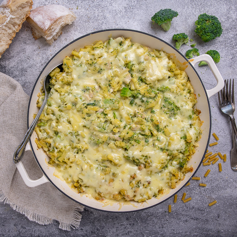 Cheesy pasta being lifted with a fork from a bowl