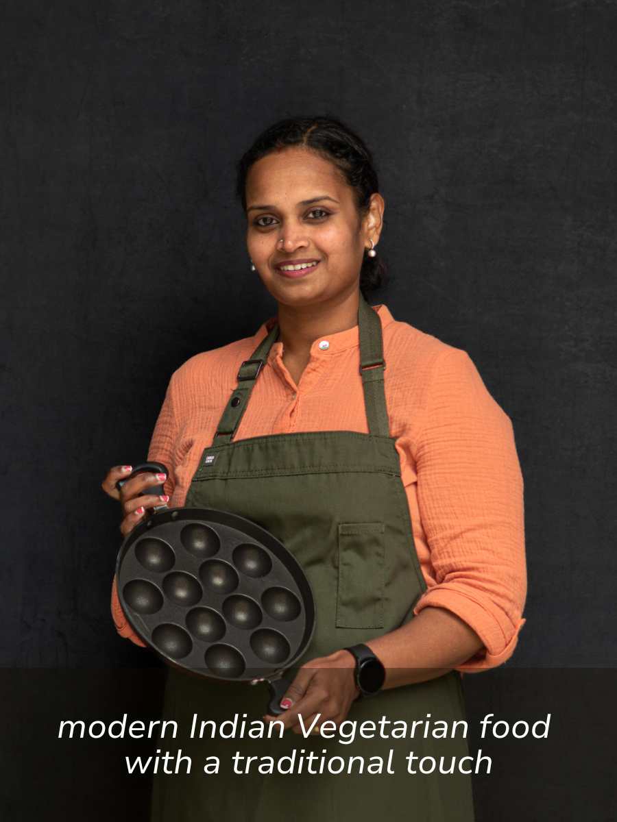 Portrait of Naga in an apron, holding her favourite pan