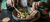 person eating a meal with a fork and knife
