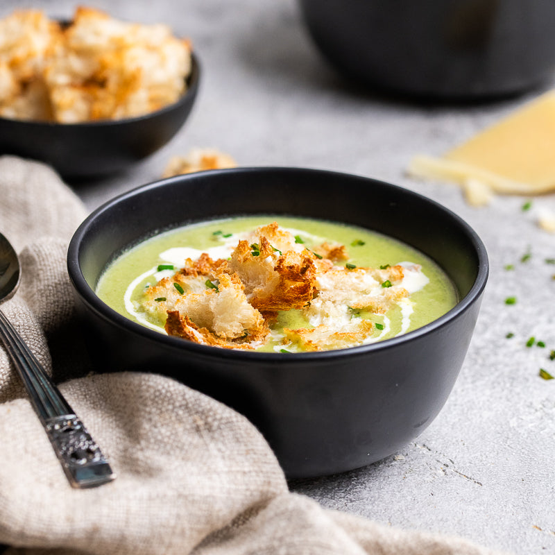 Paolo's Zucchini, leek and parmesan soup in a bowl with crusty bread 
