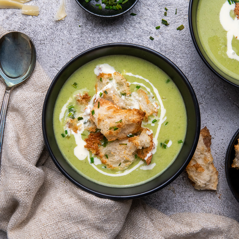 Paolo's Zucchini, leek and parmesan soup in a bowl with crusty bread 