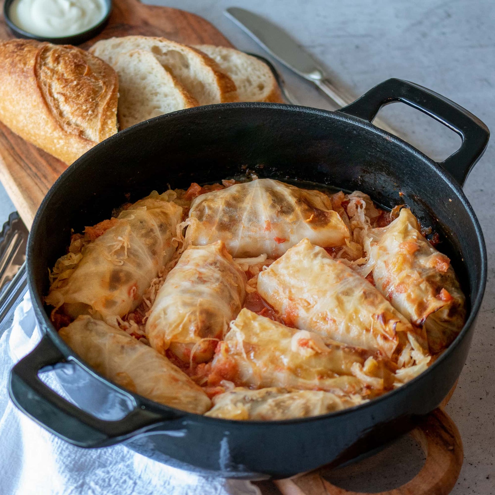 A serving of Amalia's Stuffed Cabbage Rolls topped with sour cream