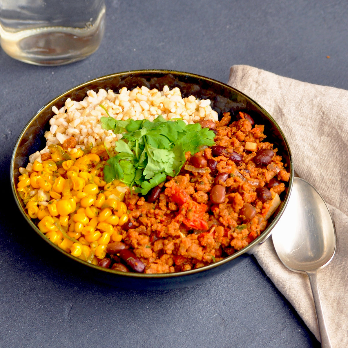 Close-up view of Ana&#39;s Mexican Bowl (V) featuring a mix of vegetables and legumes