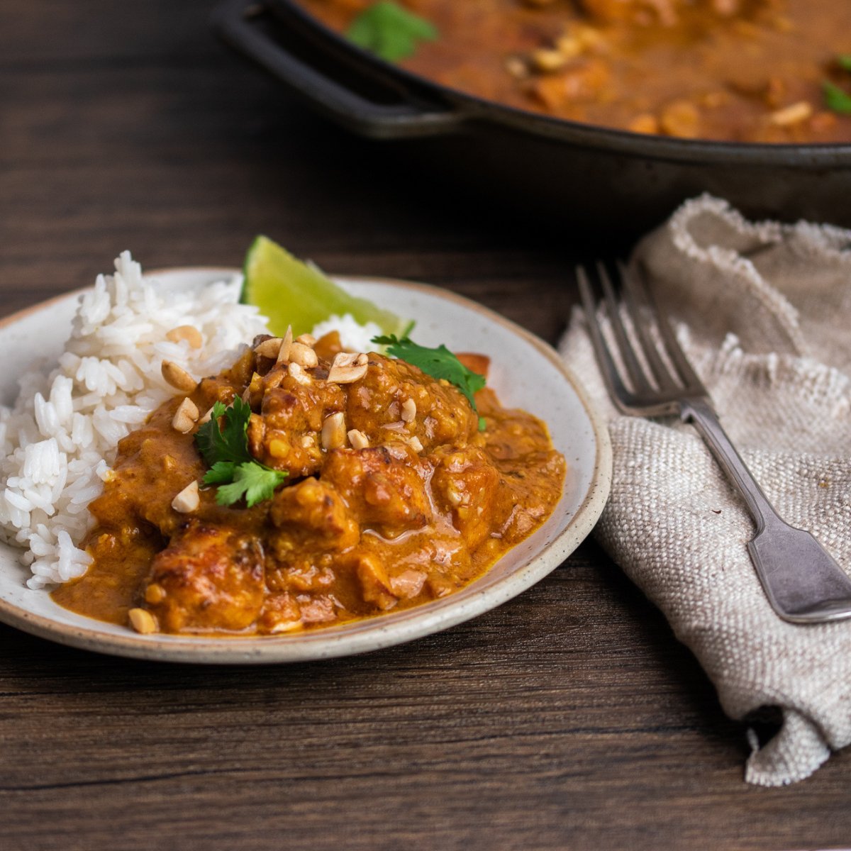 Nat&#39;s Satay Chicken with Rice and a wedge of lime on a plate