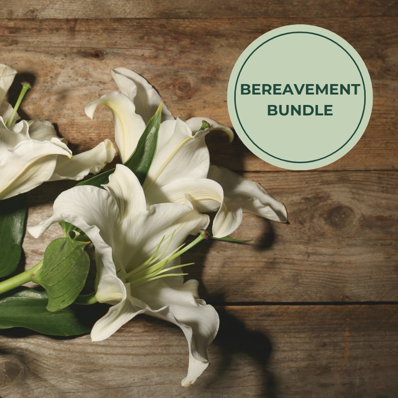 Flowers on a brown bench with circle saying &quot;Bereavement Bundle&quot;