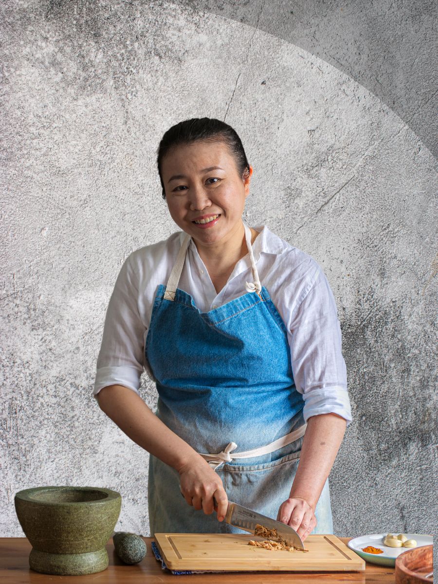 Image of Iris, Home Cook chopping ginger with grey background