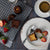 Image of David's Canelés (x5) on a plate cut in half- FoodSt