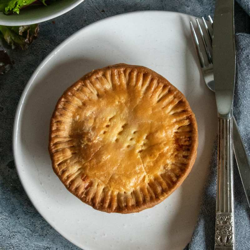 Image of Denise's Cheese & Onion Pie (Vg) cut open to show filling - FoodSt