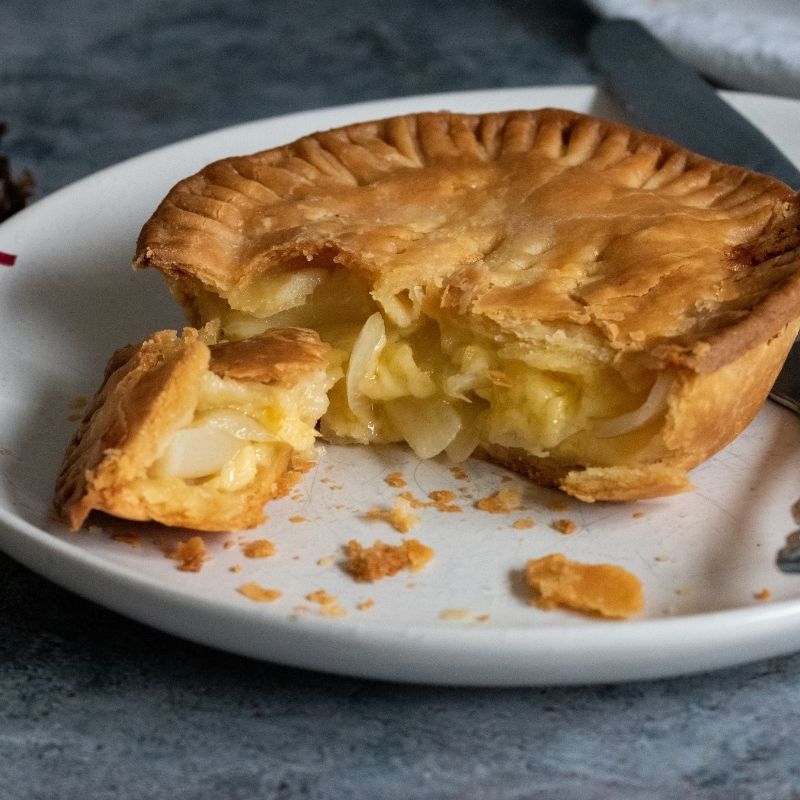 Image of Denise's Cheese & Onion Pie (Vg) cut open to show filling - FoodSt