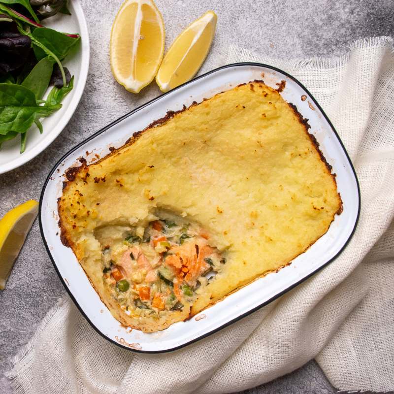 Image of Gavin&#39;s Salmon and Leek Pie in a tray with a piece served