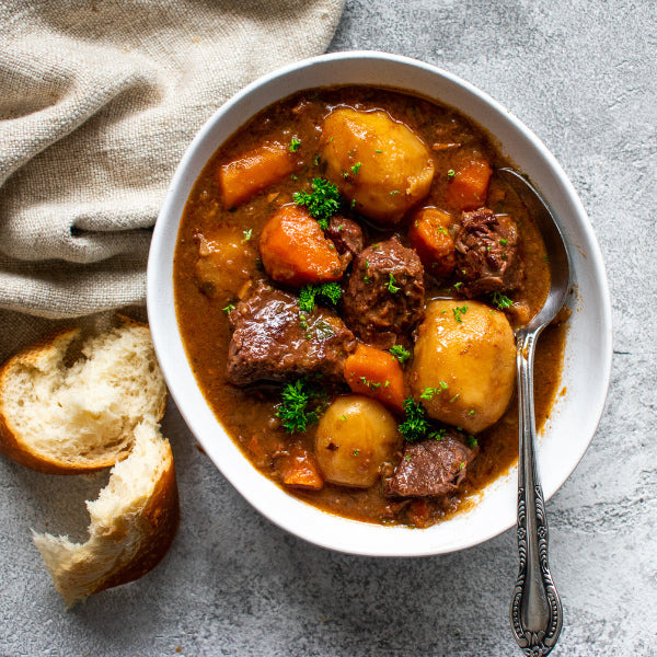 Image of Beef & Guinness Stew on table with bread